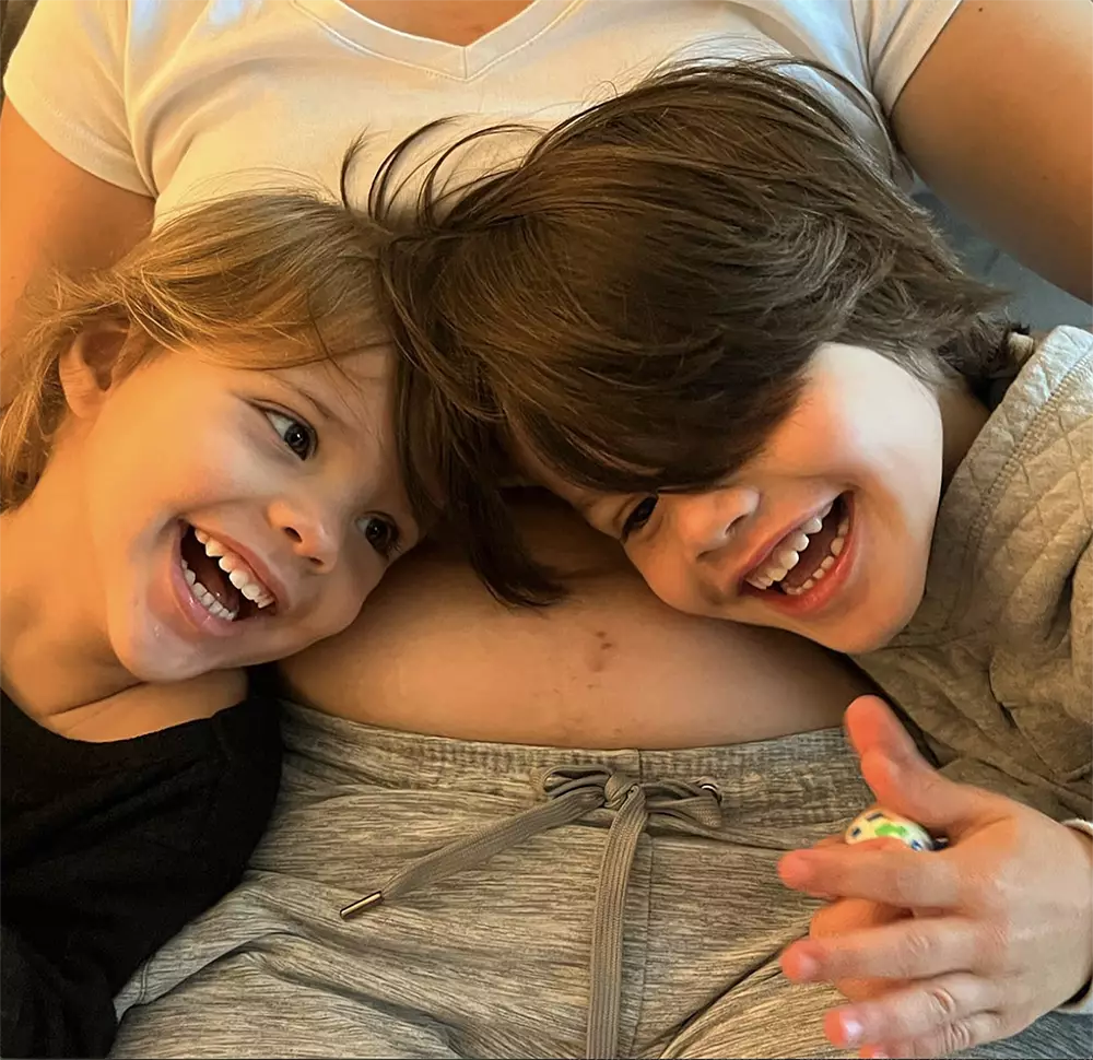 Mãe com barriga aparente com seus dois filhos - Just Real Moms